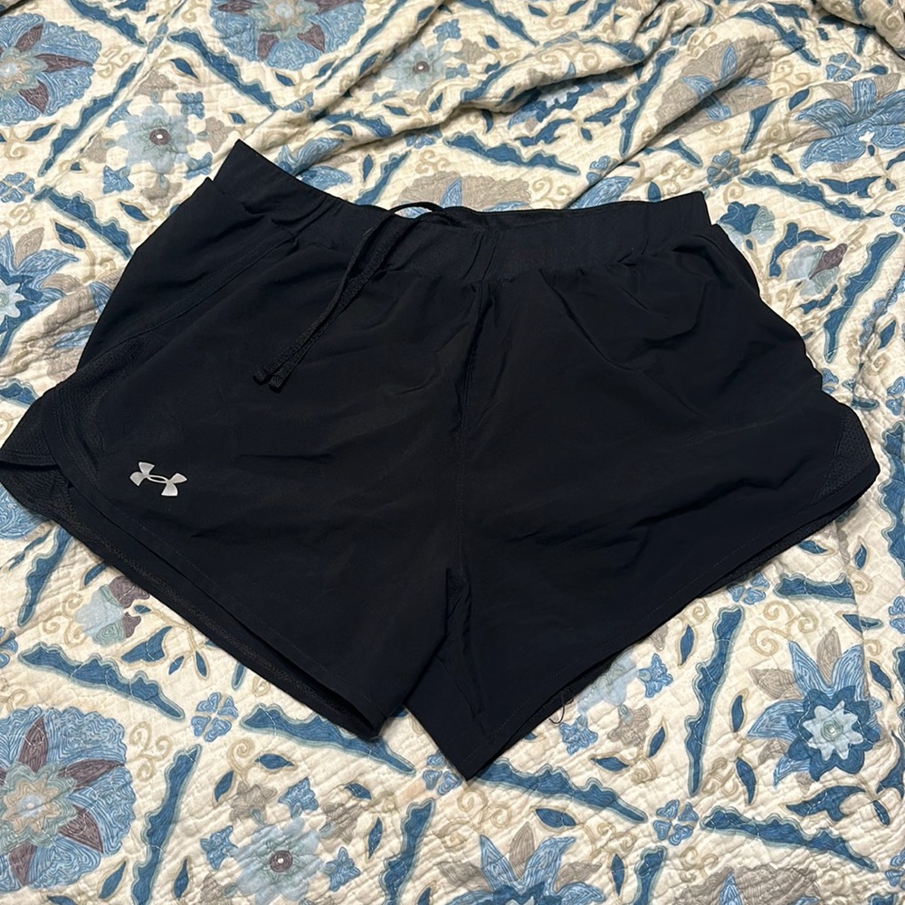 Black athletic Nike shorts with built in underwear.